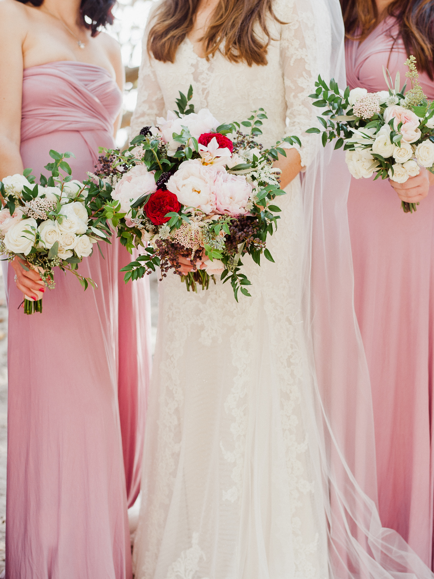 Closeup of Bride with Bridesmaids in Pink Gowns and Romantic Bouquets